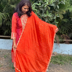 Orange color straight kurta set with embroidery