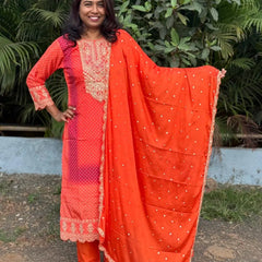 Orange color straight kurta set with embroidery