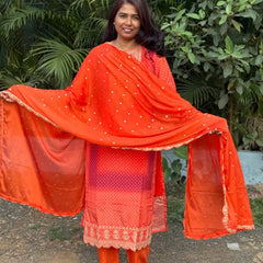Orange color straight kurta set with embroidery