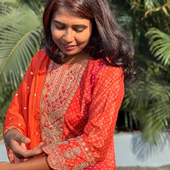 Orange color straight kurta set with embroidery
