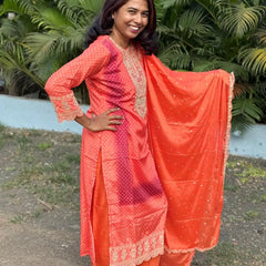 Orange color straight kurta set with embroidery